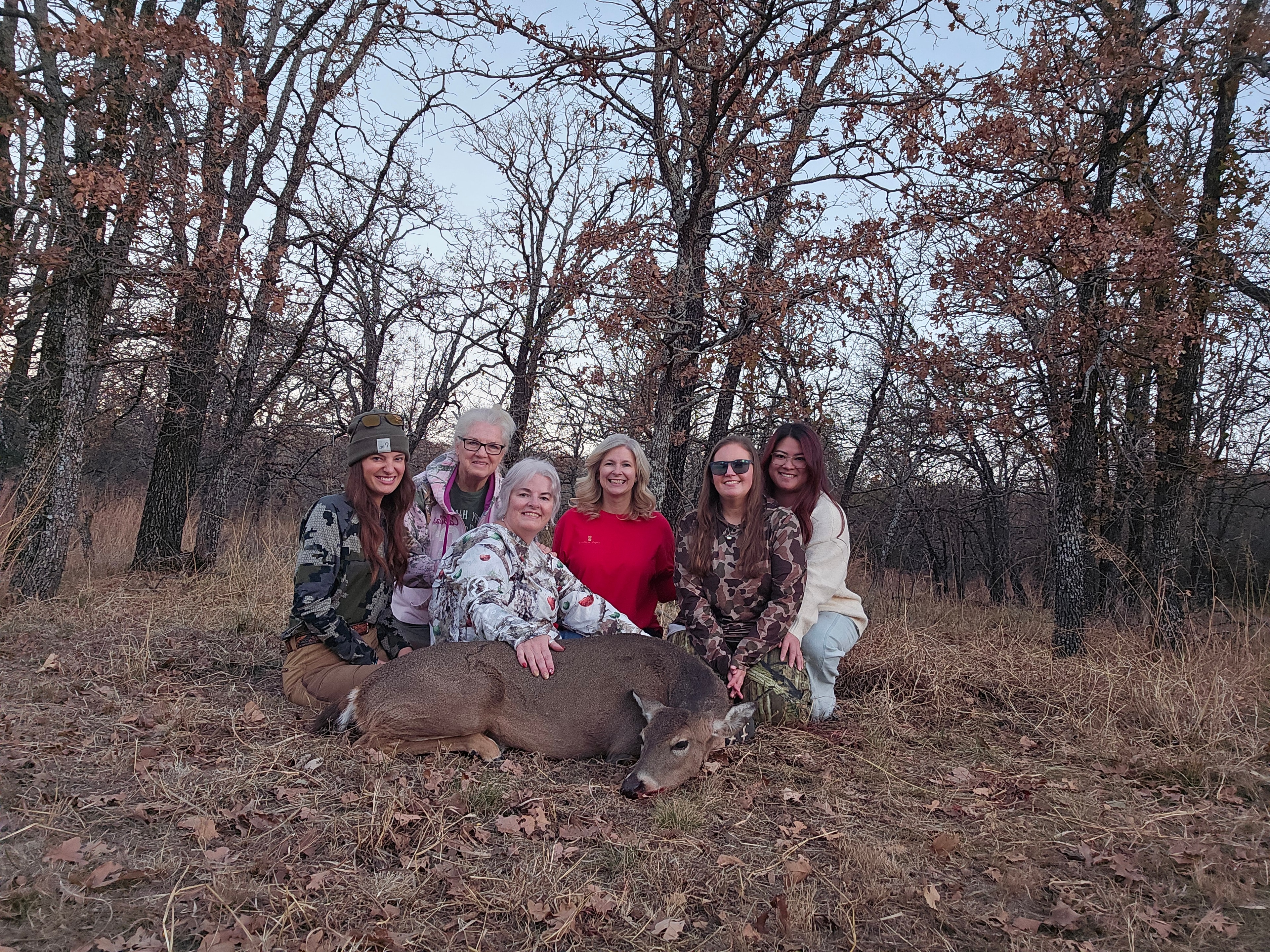 Group of women hunters with a deer at Does Before Bros Hunt